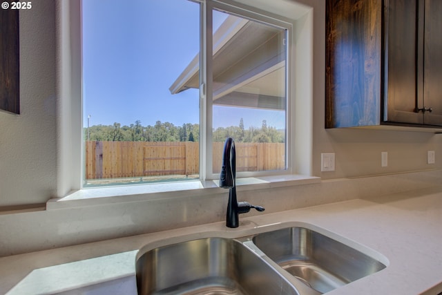 113 Citation Ct, Winston, OR 97496 - kitchen view of a sink, dark brown cabinets, and light countertops