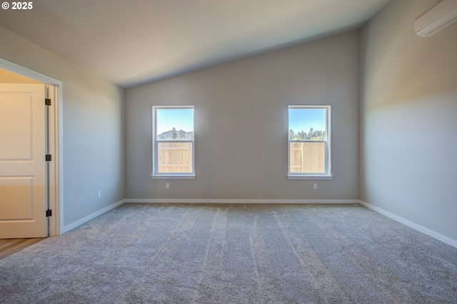113 Citation Ct, Winston, OR 97496 - carpeted spare room featuring a wall unit AC, vaulted ceiling, and baseboards