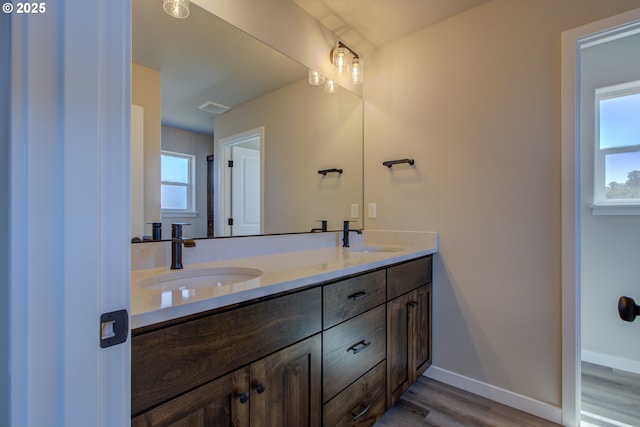 113 Citation Ct, Winston, OR 97496 - bathroom featuring double vanity, wood finished floors, and baseboards