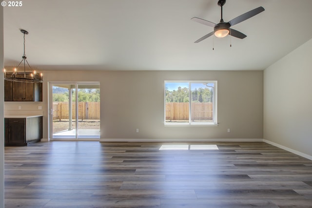 113 Citation Ct, Winston, OR 97496 - unfurnished living room featuring a chandelier, dark wood-type flooring, baseboards, and a ceiling fan