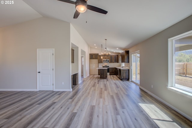 113 Citation Ct, Winston, OR 97496 - unfurnished living room with lofted ceiling, a chandelier, a sink, light wood-style floors, and a ceiling fan