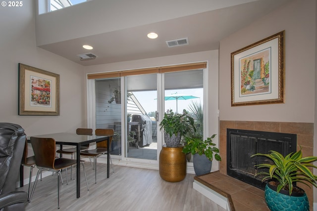 interior space with a healthy amount of sunlight, light wood-type flooring, and a fireplace