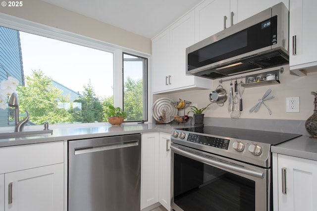 kitchen with white cabinets, stainless steel appliances, and sink