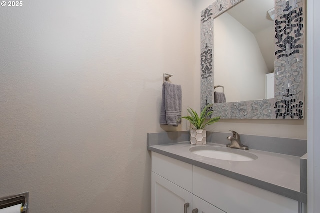 bathroom with vanity and vaulted ceiling