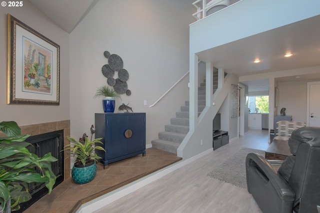 interior space featuring a tile fireplace and light hardwood / wood-style floors