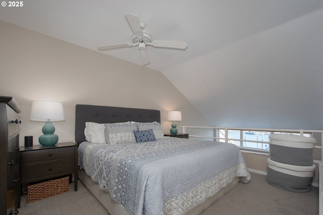 carpeted bedroom with ceiling fan and vaulted ceiling