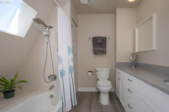 full bathroom featuring vanity, wood-type flooring, shower / tub combo, and toilet