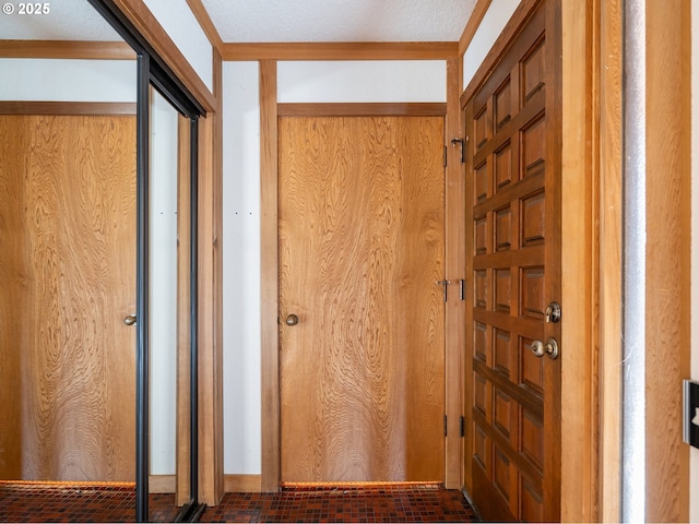 hall with ornamental molding and wood walls