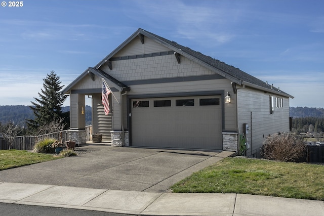 view of front of property with an attached garage, stone siding, and driveway