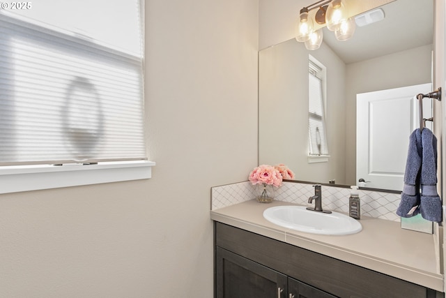 bathroom with decorative backsplash and vanity