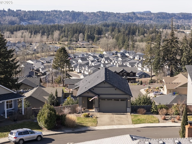 bird's eye view with a mountain view, a view of trees, and a residential view