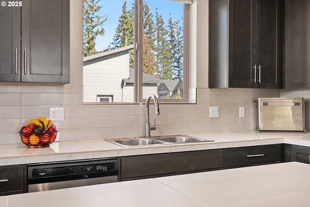 kitchen with dishwasher, a healthy amount of sunlight, decorative backsplash, and a sink