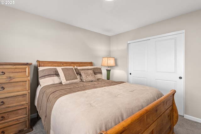 carpeted bedroom featuring baseboards and a closet
