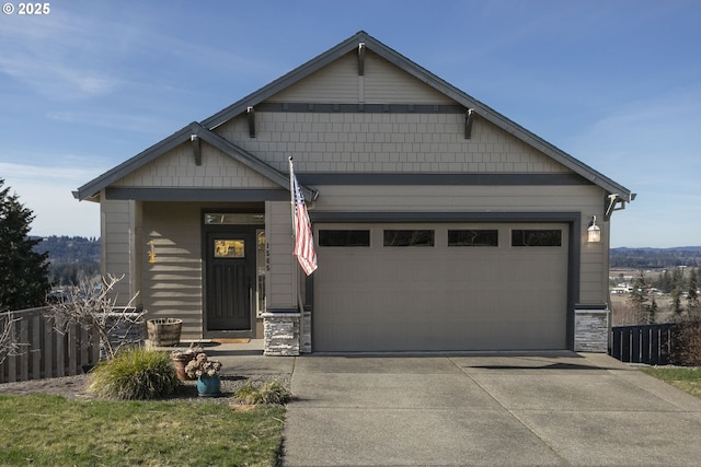 craftsman inspired home with stone siding, fence, a garage, and concrete driveway