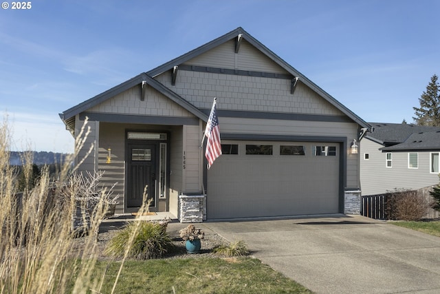 craftsman-style house featuring concrete driveway, stone siding, and a garage