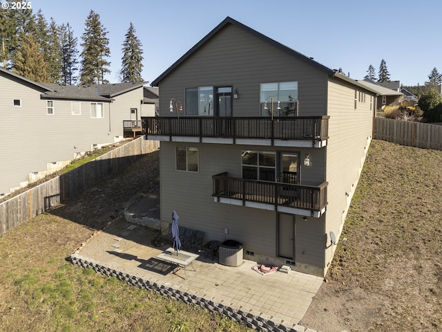 back of house with a fenced backyard, a balcony, a yard, cooling unit, and a patio area