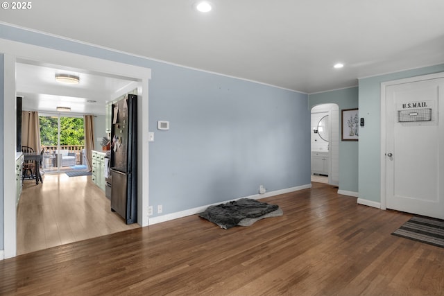 1858 5th St, Astoria, OR 97103 - empty room featuring arched walkways, baseboards, wood finished floors, recessed lighting, and ornamental molding