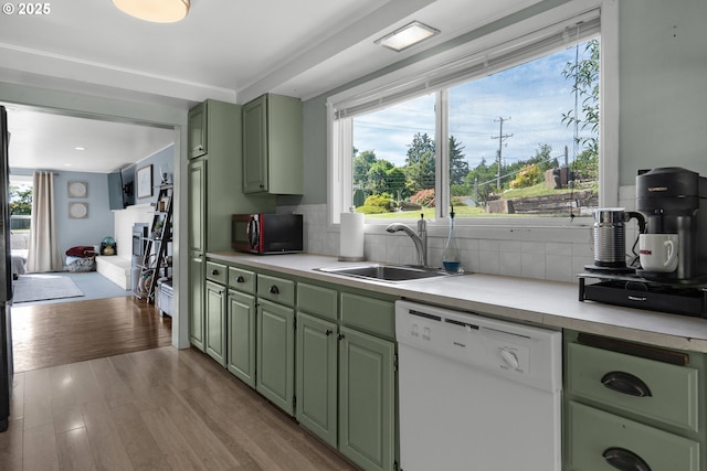 1858 5th St, Astoria, OR 97103 - kitchen featuring green cabinets, white dishwasher, black microwave, a sink, and light countertops