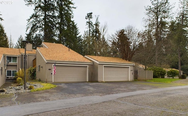 view of front of house featuring a garage and fence