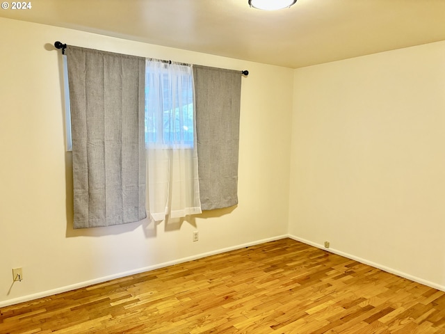 empty room with wood-type flooring