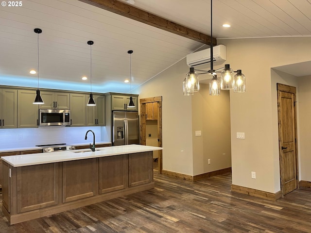 88366 4th Ave, Florence, OR 97439 - kitchen with a sink, a kitchen island with sink, stainless steel appliances, a wall mounted AC, and dark wood-style floors