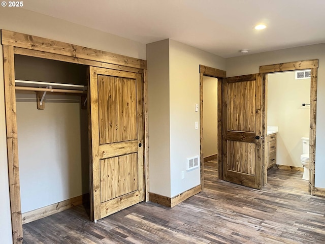 88366 4th Ave, Florence, OR 97439 - unfurnished bedroom with a closet, baseboards, visible vents, and dark wood-type flooring