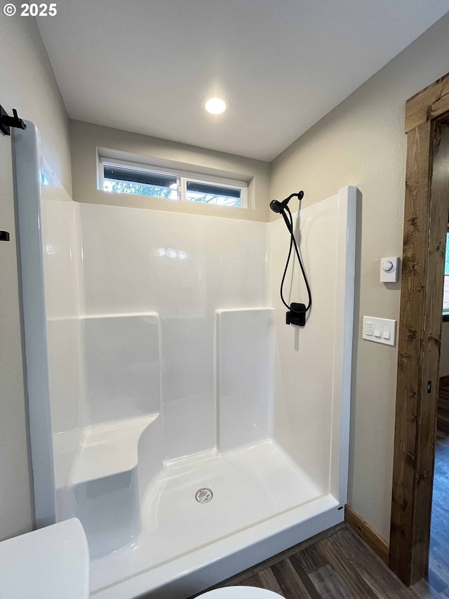 88366 4th Ave, Florence, OR 97439 - bathroom featuring walk in shower, wood finished floors, a wealth of natural light, and toilet
