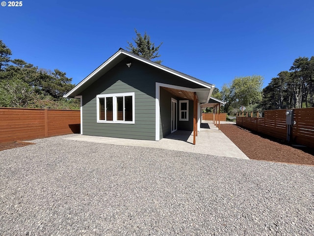 88366 4th Ave, Florence, OR 97439 - back of property with a patio area and a fenced backyard