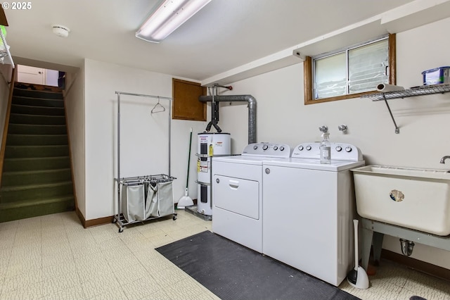 washroom with electric water heater, light floors, laundry area, separate washer and dryer, and a sink