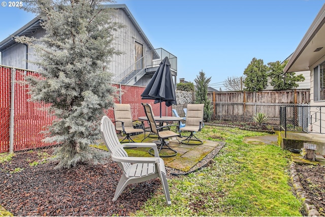 view of yard featuring a patio, stairway, and a fenced backyard