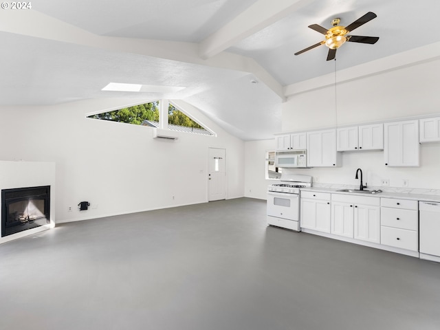 kitchen featuring sink, white appliances, ceiling fan, white cabinetry, and beamed ceiling