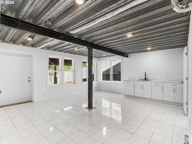 basement with light tile patterned flooring and indoor wet bar