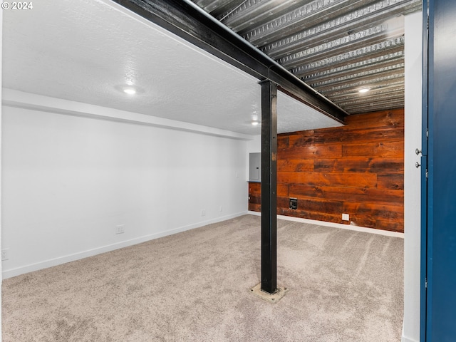 basement with electric panel, carpet floors, and wood walls