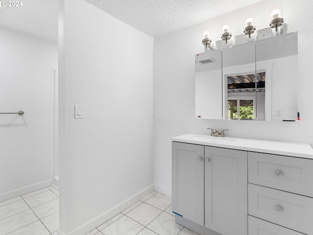 bathroom featuring vanity and a textured ceiling