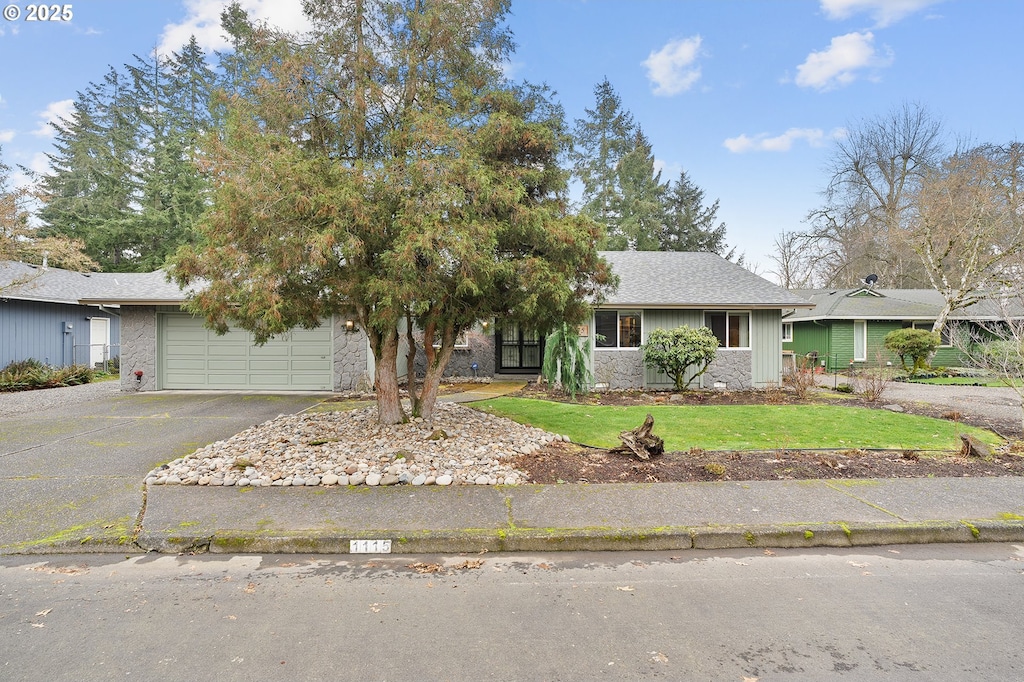 view of front of house with a garage and a front lawn