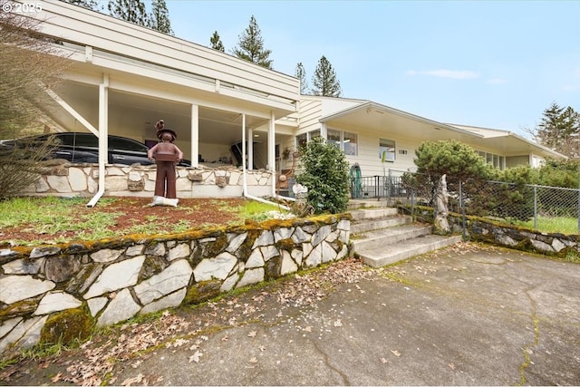 view of front facade featuring fence