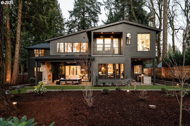 back of house featuring a patio, fence, and a balcony