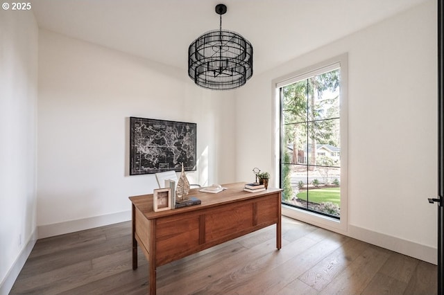 office area with a healthy amount of sunlight, baseboards, and wood finished floors