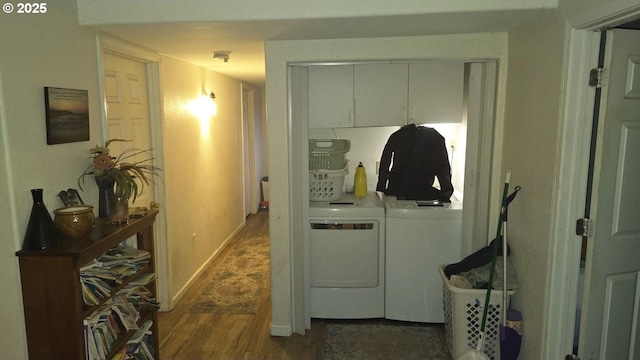 laundry area featuring washing machine and dryer and dark hardwood / wood-style floors