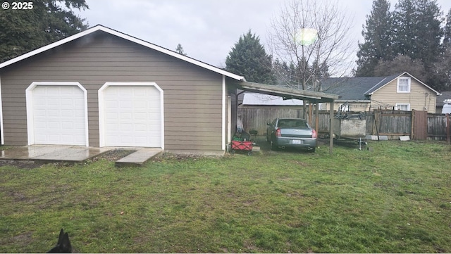 garage with a yard and a carport