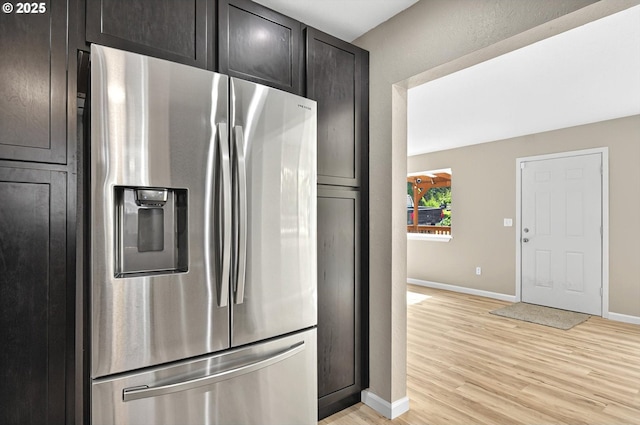 11097 Colvin Rd, Clatskanie, OR 97016 - kitchen with light wood finished floors, stainless steel refrigerator with ice dispenser, and baseboards