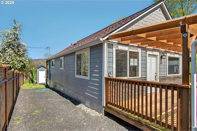 11097 Colvin Rd, Clatskanie, OR 97016 - view of home's exterior featuring fence, a shed, crawl space, an outdoor structure, and a deck