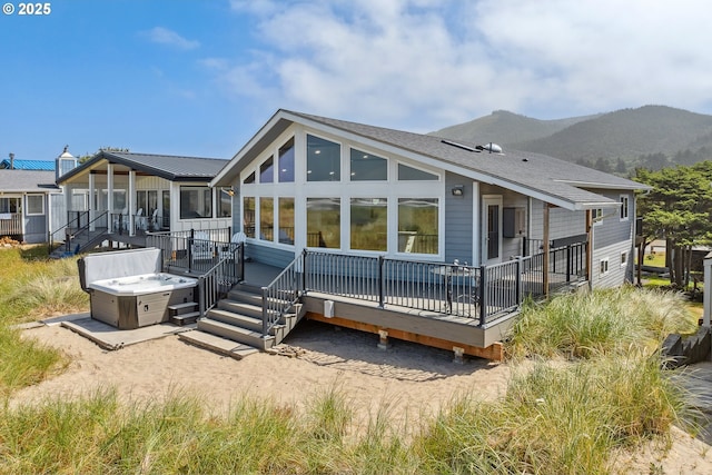 26280 Beach Dr, Rockaway Beach, OR 97136 - rear view of house with a sunroom and a deck with mountain view