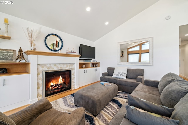 26280 Beach Dr, Rockaway Beach, OR 97136 - living area featuring recessed lighting, a tile fireplace, wood finished floors, and high vaulted ceiling