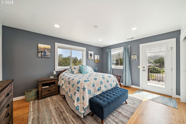 26280 Beach Dr, Rockaway Beach, OR 97136 - bedroom with access to outside, multiple windows, wood finished floors, and recessed lighting