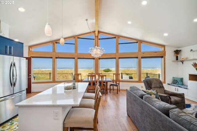 26280 Beach Dr, Rockaway Beach, OR 97136 - kitchen with freestanding refrigerator, a chandelier, light wood-style floors, recessed lighting, and pendant lighting