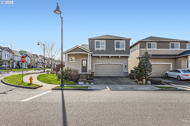 view of front facade with a garage, a residential view, and driveway