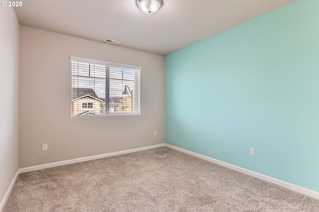 unfurnished room with carpet, baseboards, and visible vents