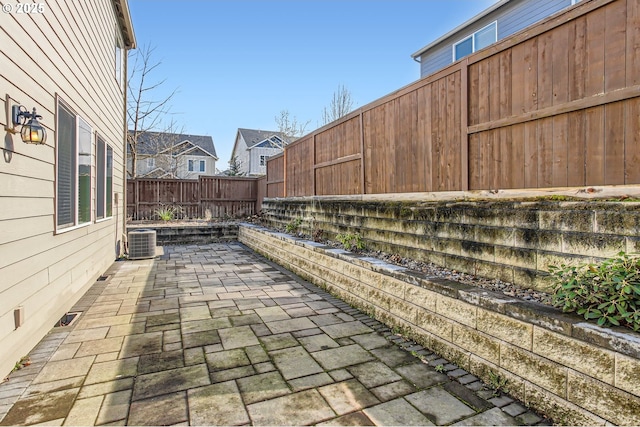 view of patio featuring central air condition unit and a fenced backyard