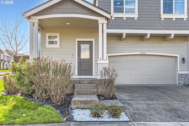 doorway to property with an attached garage and driveway